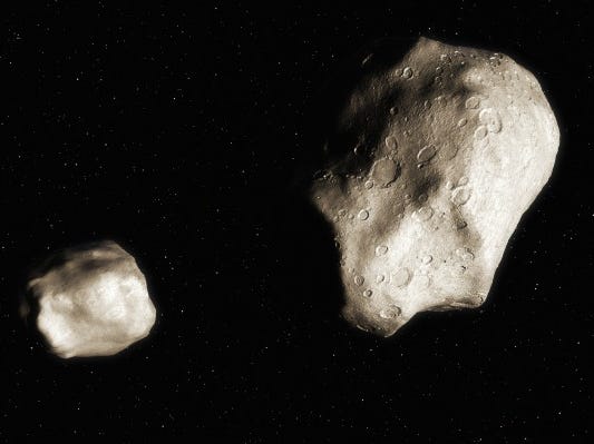 due asteroidi uno grande uno piccolo nello spazio nero