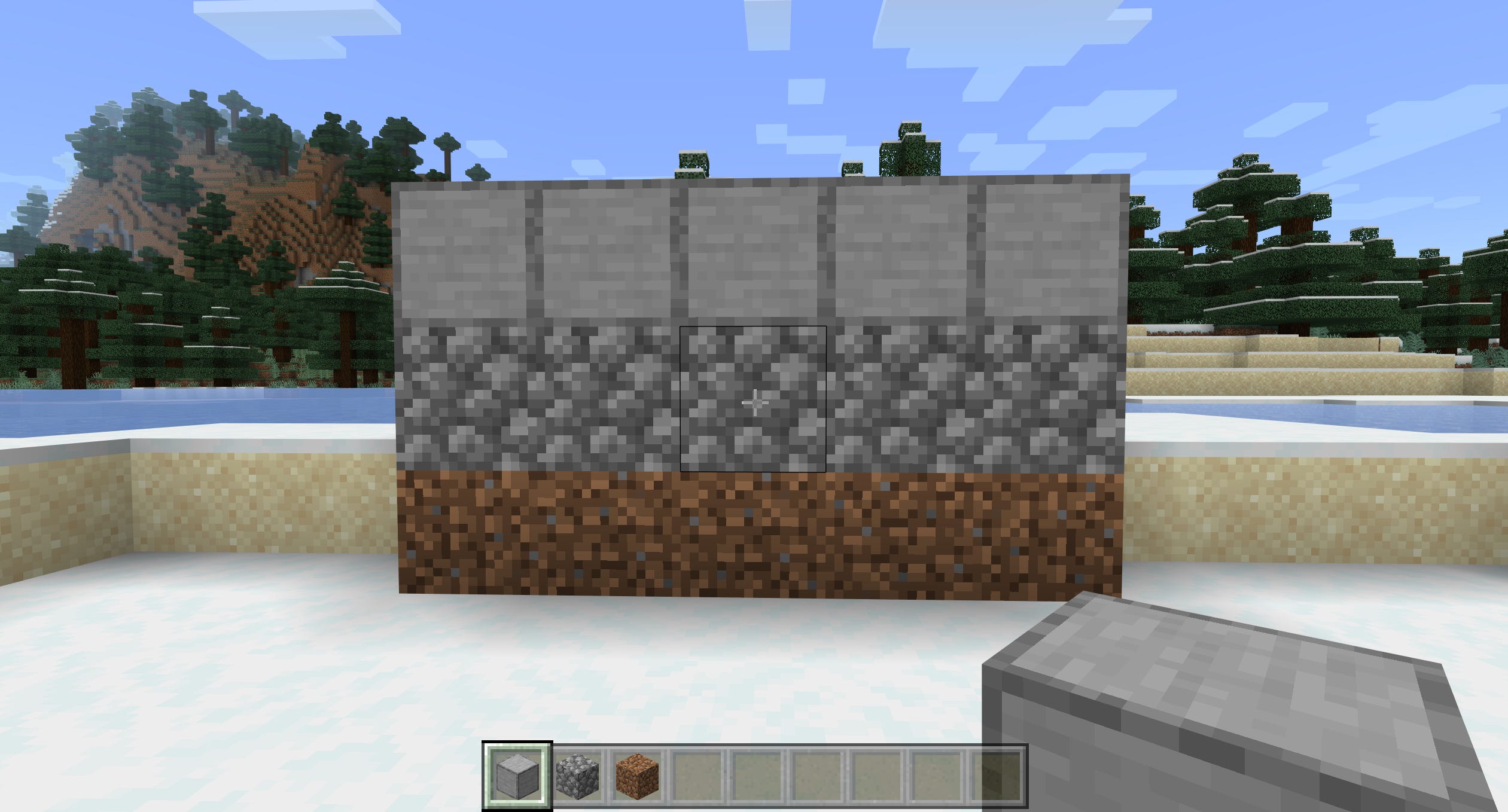 Una linea di terra, una linea di ciottoli e una linea di pietra liscia in Minecraft.
