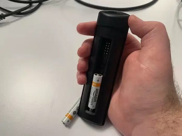 Il retro di un telecomando Firestick, con il coperchio della batteria e una delle batterie rimosse.